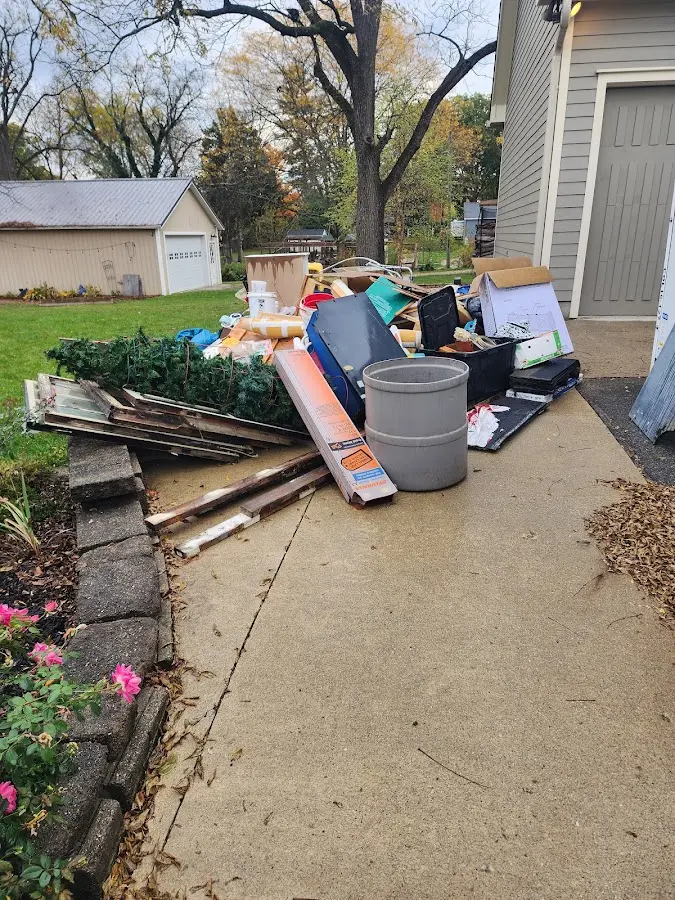 Dumpster being loaded with debris for Estate Cleanout Dumpster Rental in Little Silver